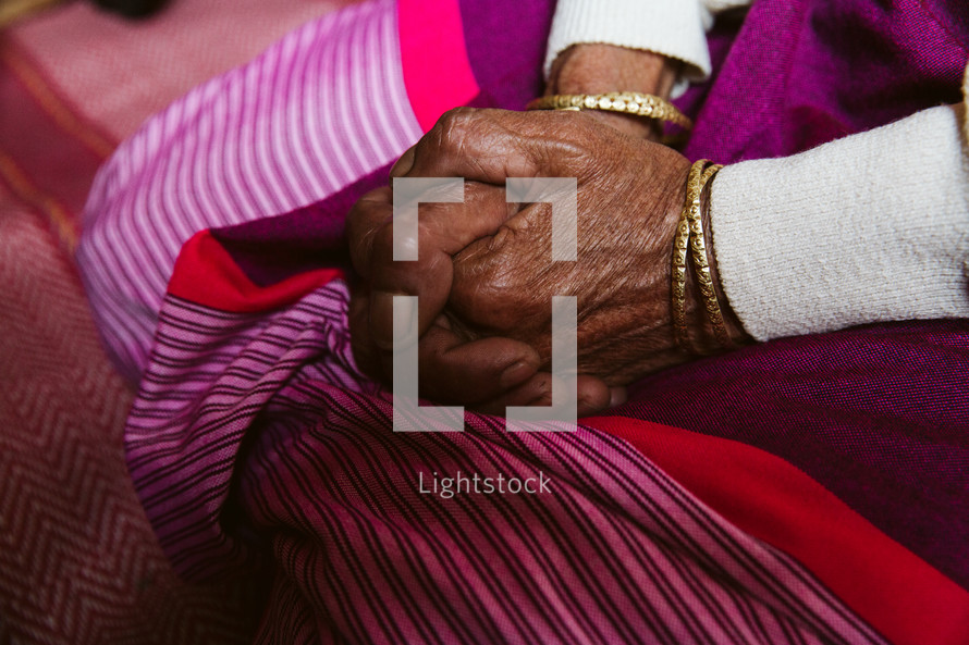 woman's hands folded in prayer