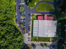 aerial view over a church and parking lot 