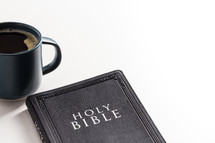 coffee mug and Holy Bible on a white background 