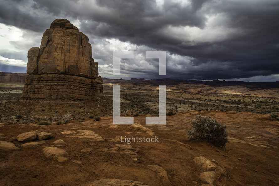 Late afternoon storms roll over the desert landscape in Arches National Park in Moab Utah