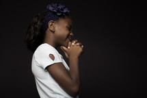 a girl child praying 