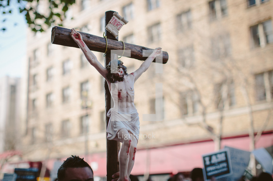 A man carrying a crucifix in a pro-life march 