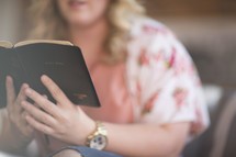 a woman reading a Bible at a Bible study 