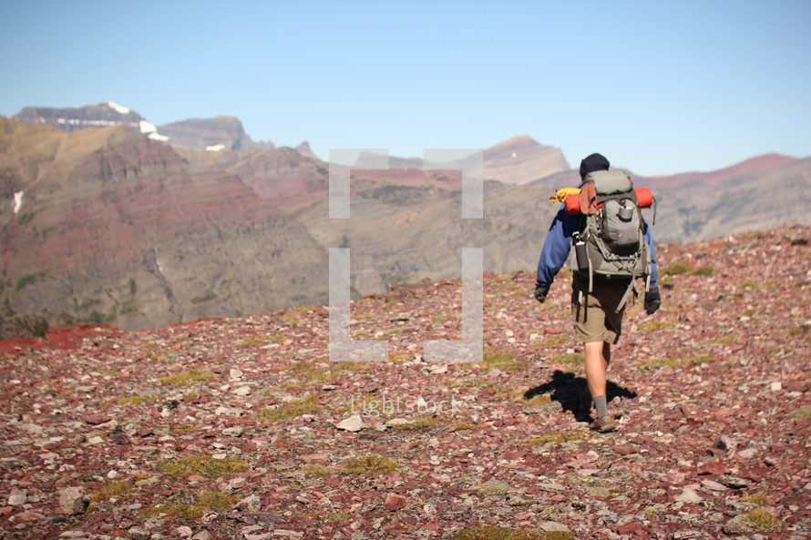 a man hiking on a rugged landscape 
