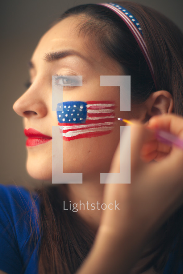 woman face pairing a flag for July 4th