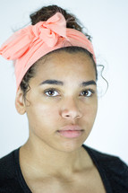 head shot of a young woman with a headband 