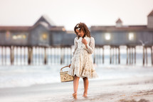 child with a basket waling on a beach 