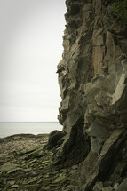 rocky cliffs along a shore 