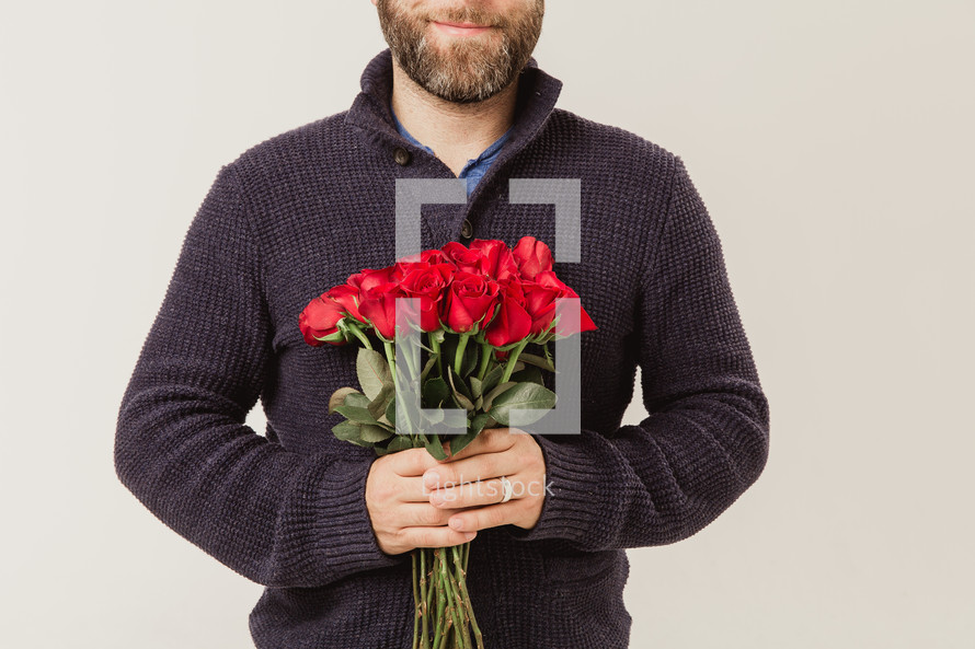 man holding red long stem roses 