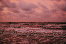 pink clouds over the ocean at sunset 