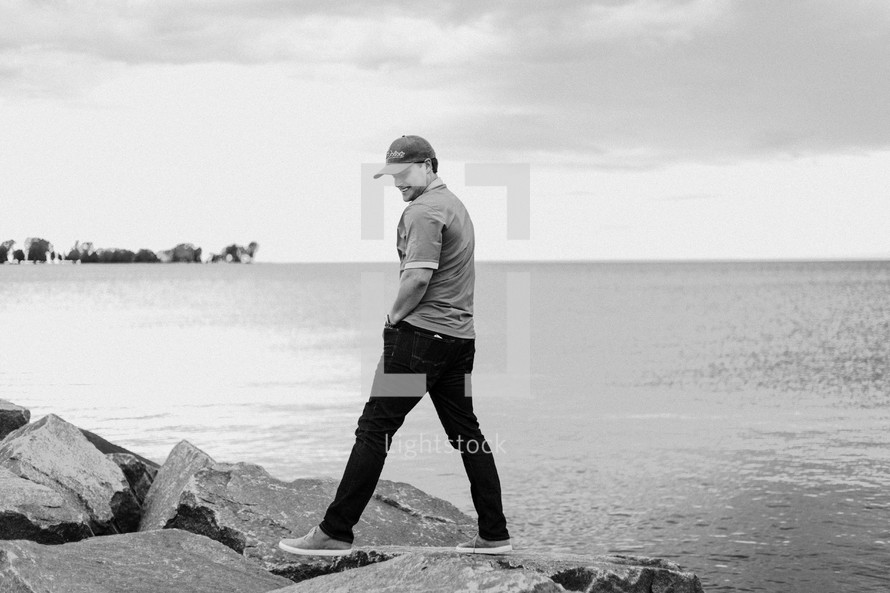 a man standing on a rocky beach 