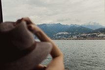 a woman with a hat on a ferry 