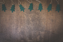 Christmas tree paper ornaments on wood background 