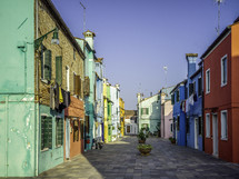 Brightly colored homes on street with pavers