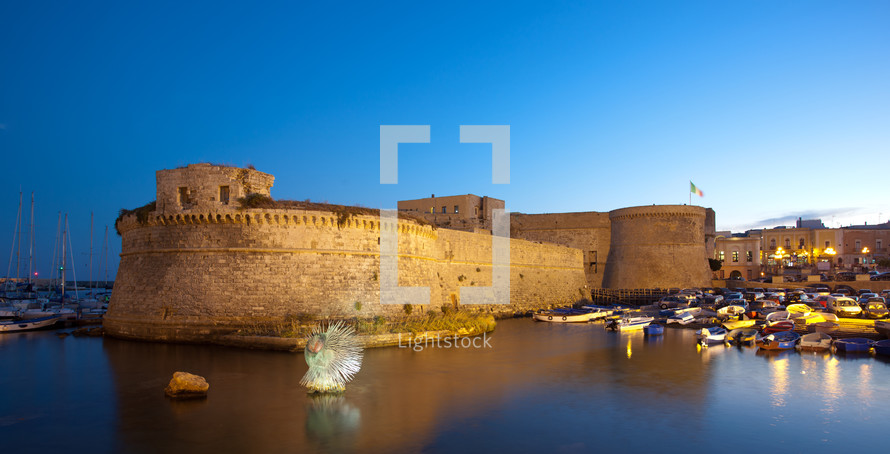 Angevin Castle of Gallipoli by night in Salento, Italy.