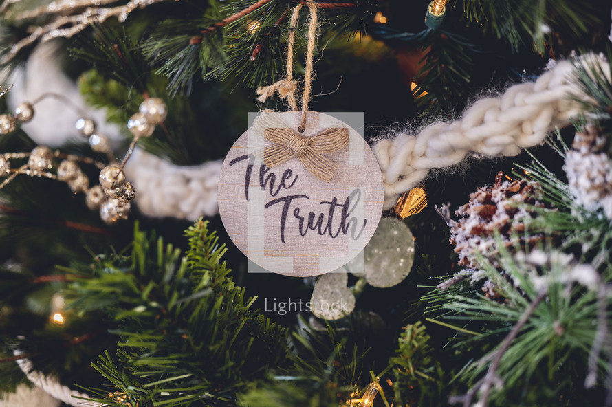 Wooden ornament with the word "the Truth" on a Christmas tree 