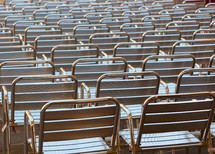 Empty metal seats places in public space.