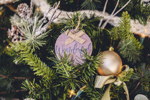 Wooden ornament with the word "wonderful" on a Christmas tree 