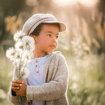 a boy picking flowers 