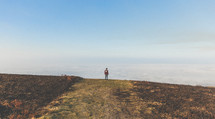 a man standing on a mountaintop above the clouds 