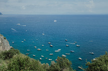 boats on the water by a shoreline in Italy