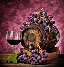 grapes and wine on a purple background 