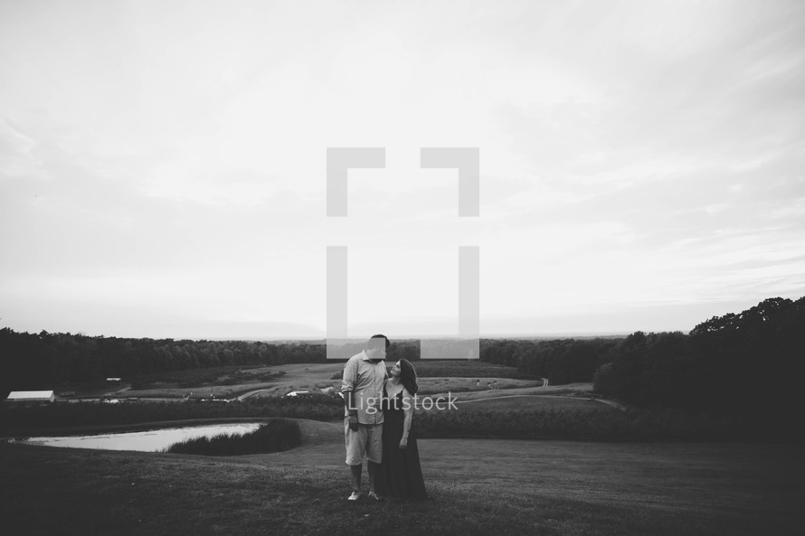 a couple hugging outdoors in black and white 