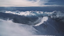 Panoramic view of blue misty mountains in cold frozen winter landscape.
