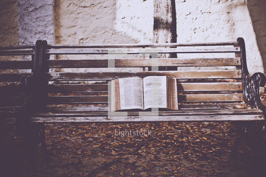 opened Bible on a bench 