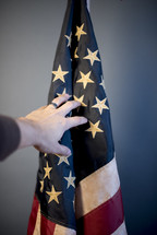hand reaching towards an American flag 