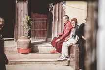 men sitting outdoors in Tibet