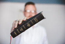 man holding a Spanish Bible - Santa Biblia 