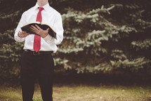 young man holding a Bible 