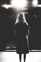 woman standing alone on stage 