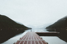 a dock over a foggy lake 