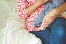 a grandmother cradling a newborn 
