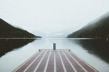 dock over a foggy lake 