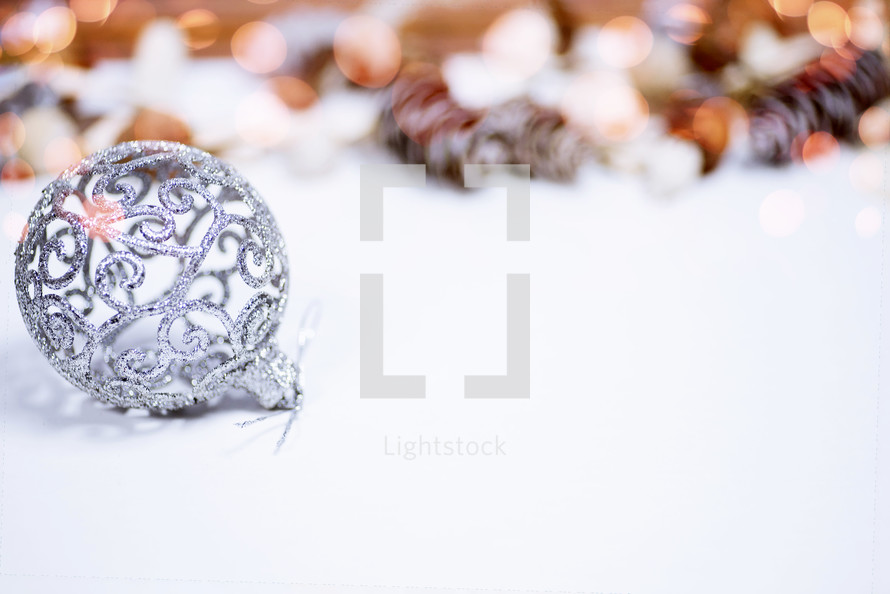 silver Christmas ornament and bokeh lights 