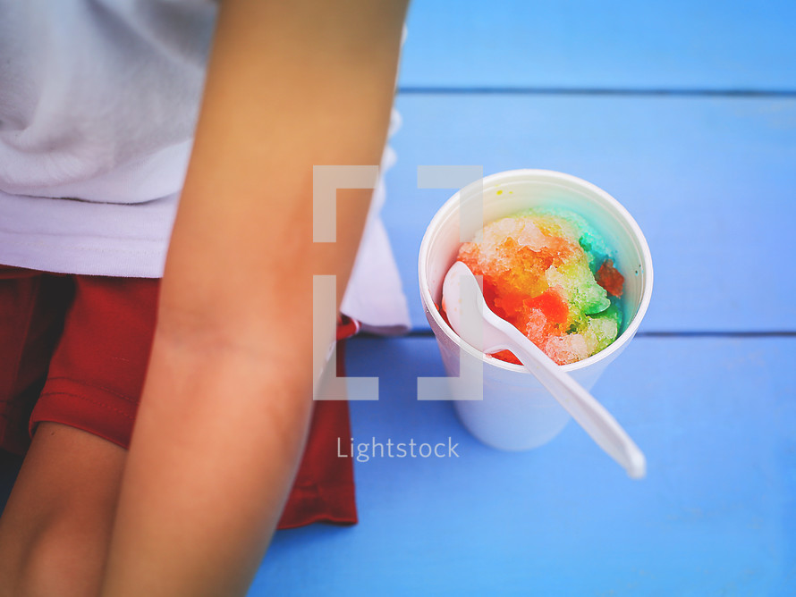 a child eating a snow cone 