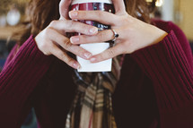 girl holding a coffee cup 