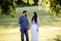 portrait of a couple holding hands outdoors 