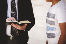 a man reading scripture to a stranger 