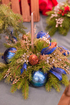 gold candle and Christmas greenery decorations 