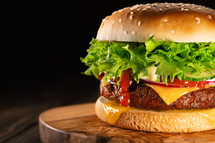 Tasty burger with smoke, fast food. Fresh homemade grilled hamburger meat patty. High quality photo