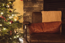 Cozy chair next to Christmas tree and fire place