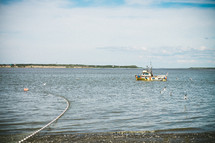 Fishing boat and nets in the ocean water.
