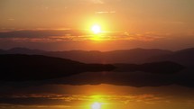 Golden sunset over mountains lake with beautiful evening colors Time lapse
