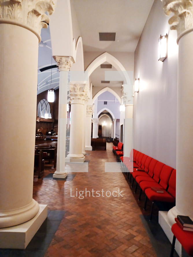 Traditional church with arches and red overflow chairs
