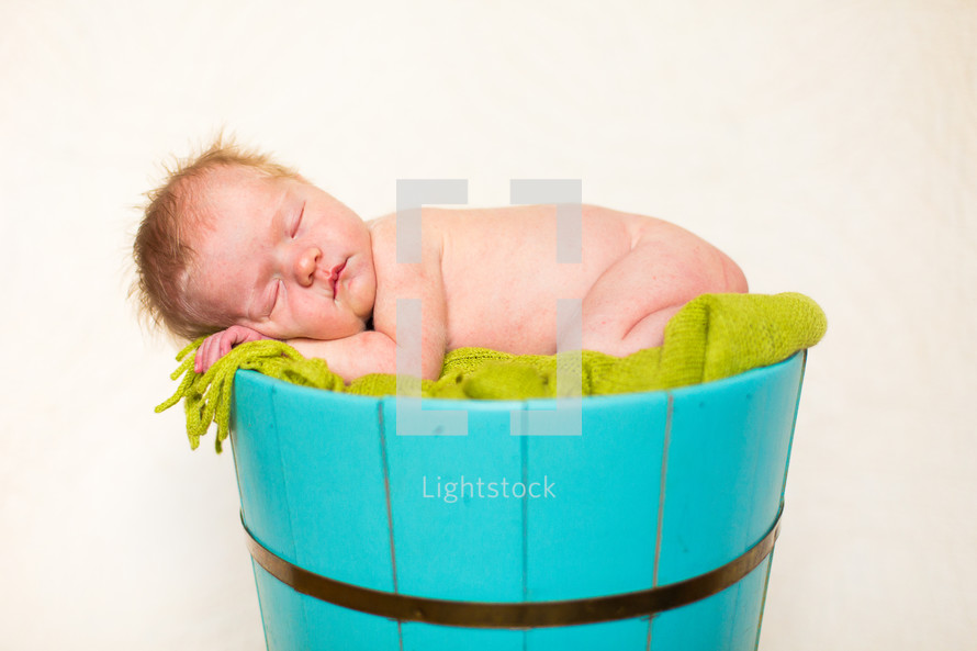 naked newborn in a barrel 