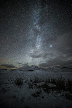 stars over a snow covered landscape 